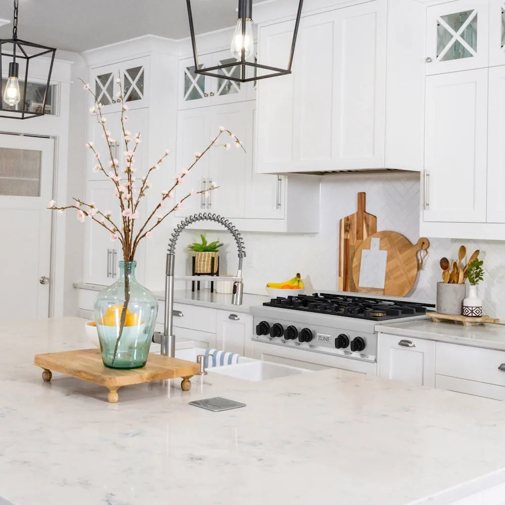 ZLINE Autograph Edition 36 in. Legacy Gas Rangetop with 6 Burners and Porcelain Cooktop in Stainless Steel with Matte Black Accents (RTZ-36-MB) in a farmhouse kitchen with white cabinets, marble countertops, and decorative elements.