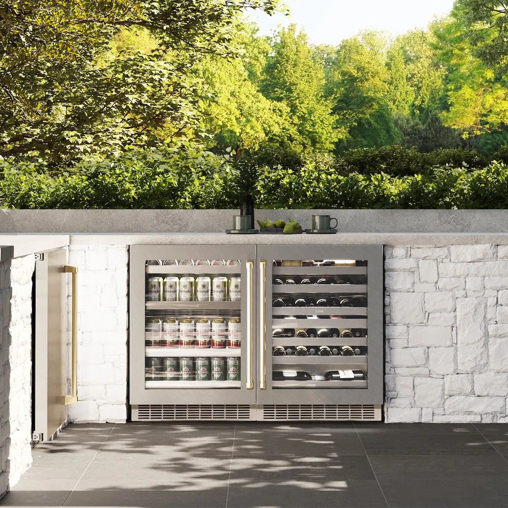 ZLINE Autograph Edition 24 in. Touchstone 151 Can Beverage Fridge With Satin Stainless Steel Glass Door And Champagne Bronze Handle (RBSOZ-SN-24-CB) front, in a luxury outdoor kitchen.