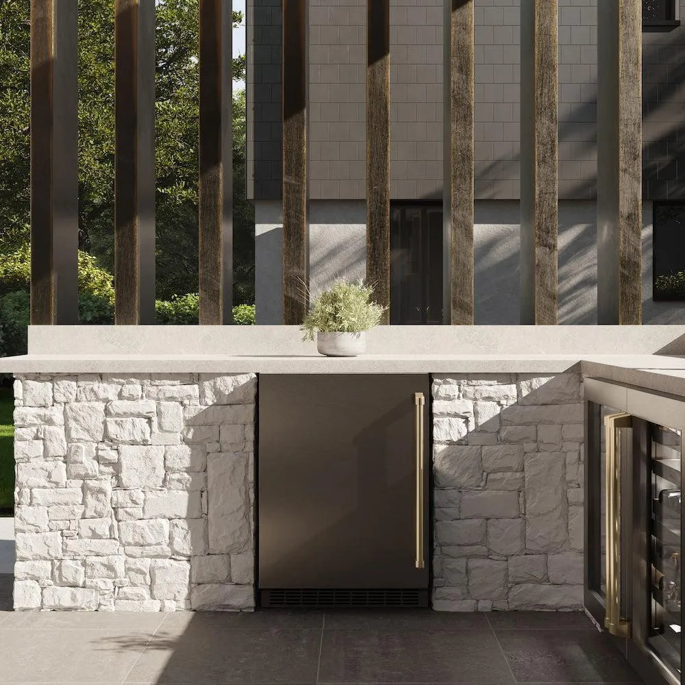 ZLINE Autograph Edition 24 in. Touchstone 151 Can Beverage Fridge With Solid Stainless Steel Door And Champagne Bronze Handle (RBSOZ-ST-24-CB) front, in a luxury outdoor kitchen.