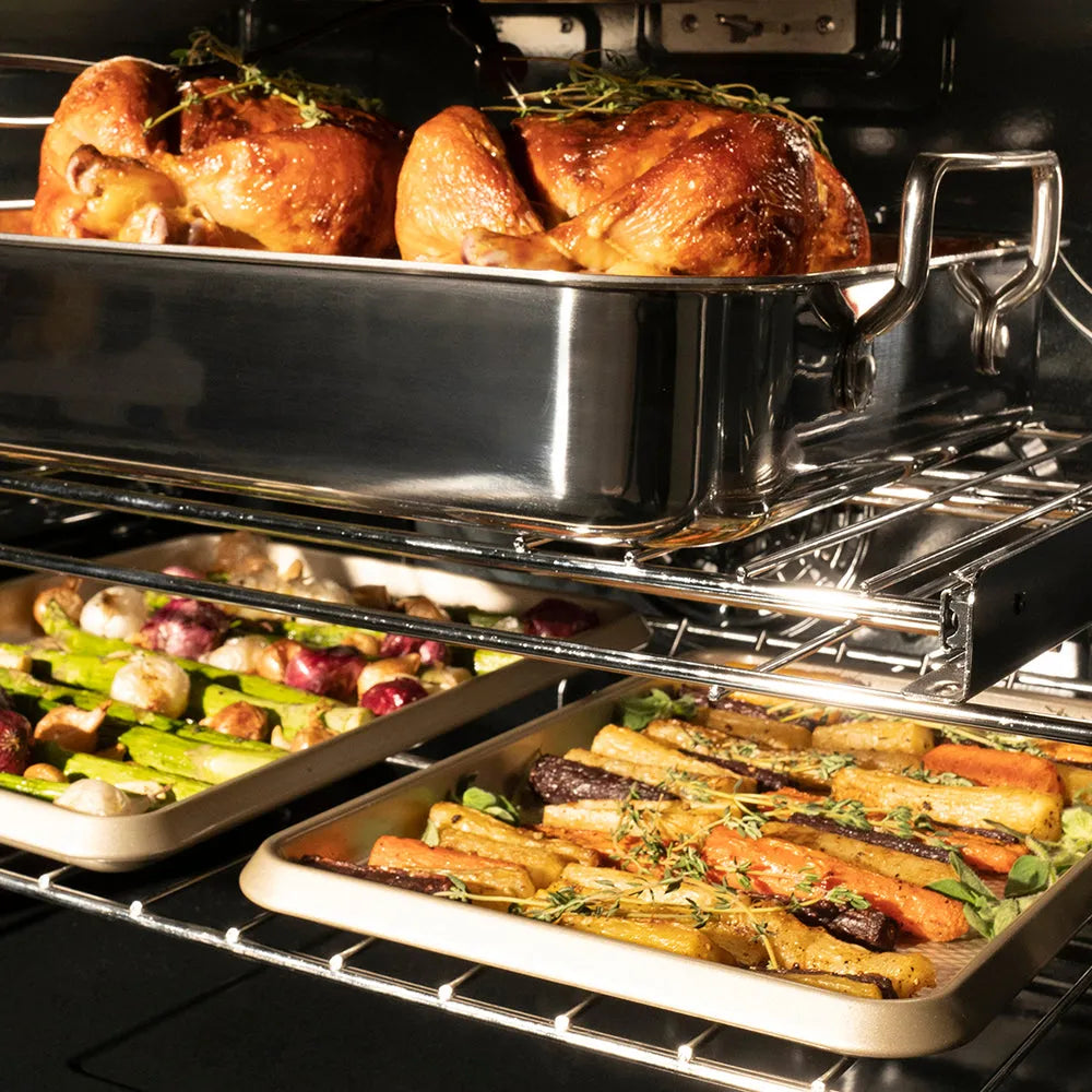 ZLINE Autograph Edition 30 in. Professional True Convection Double Wall Oven with Air Fry and Self Clean in Stainless Steel with Polished Gold Helix Handles (WADZ-30-KG) oven interior with roasted chickens with herbs, showing the cooking process.