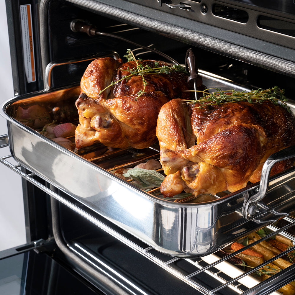 ZLINE Autograph Edition 30 in. Professional True Convection Single Wall Oven with Air Fry and Self Clean in Stainless Steel with Polished Nickel Helix Handle (WASZ-30-KPN) oven interior with roasted chickens with herbs, showing the cooking process.