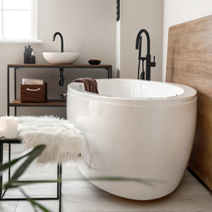 ZLINE Emerald Bay Bath Tub Filler with Hand Shower in Matte Black (EMBY-BTF-MB) in a luxury bathroom with large bathtub.