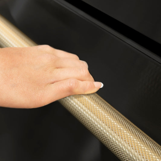 ZLINE Autograph Edition 24 in. Touchstone 168 Can Outdoor-Rated Dual Refrigerator Drawer with Black Stainless Steel Doors and Champagne Bronze Helix Handles (RDSOZ-BS-24-KCB) hand holding Helix handle showing knurled diamond texture.