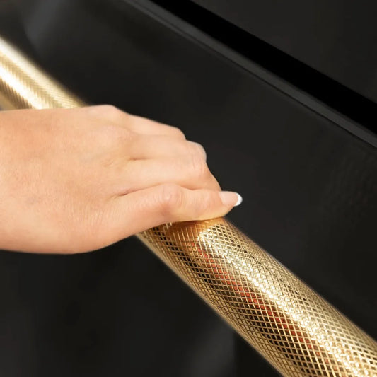 ZLINE Autograph Edition 24 in. Touchstone 168 Can Outdoor-Rated Dual Refrigerator Drawer with Black Stainless Steel Doors and Polished Gold Helix Handles (RDSOZ-BS-24-KG) Helix handle close-up showing knurled diamond texture.
