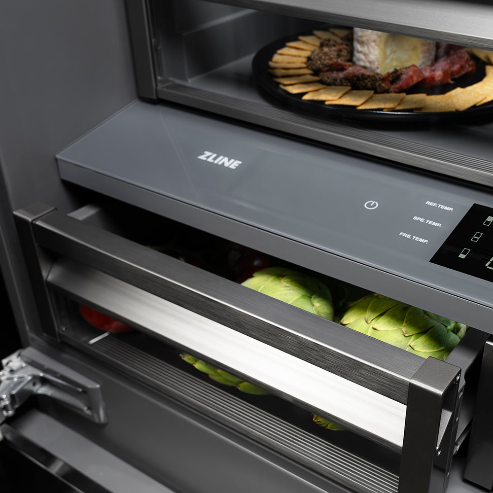 ZLINE Autograph Edition 36 in. 19.6 cu. ft. French Door Built-In Bottom Freezer Refrigerator with Water Dispenser and Ice Maker in Black Stainless Steel with Graphite Gray Interior and Champagne Bronze Helix Handles (GRBIVZ-BS36KCB) flex drawer with fresh produce inside and shelves displaying various food items.