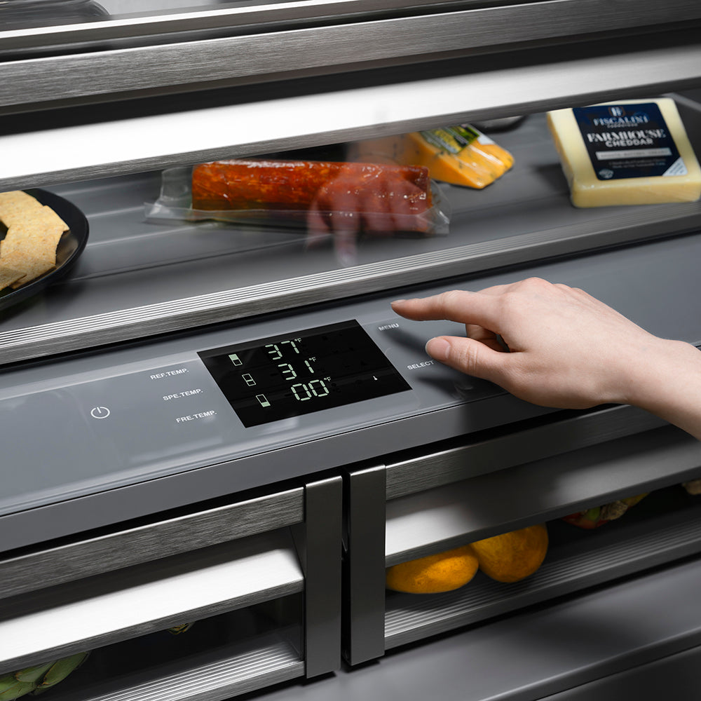 ZLINE Autograph Edition 36 in. 19.6 cu. ft. French Door Built-In Bottom Freezer Refrigerator with Water Dispenser and Ice Maker in Black Stainless Steel with Graphite Gray Interior and Polished Gold Helix Handles (GRBIVZ-BS36KG) hand adjusting digital touch temperature control inside refrigeration compartment with food items.