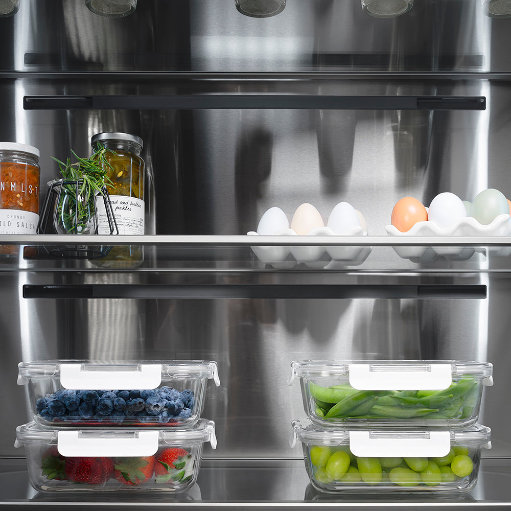 ZLINE Autograph Edition 36 in. 19.6 cu. ft. French Door Built-In Bottom Freezer Refrigerator with Water Dispenser and Ice Maker in Black Stainless Steel with Stainless Steel Interior and Polished Gold Helix Handles (SRBIVZ-BS36KG) refrigeration compartment interior with food storage containers on a shelf.