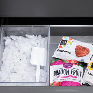 ZLINE Autograph Edition 36 in. 19.6 cu. ft. French Door Built-In Bottom Freezer Refrigerator with Water Dispenser and Ice Maker in Stainless Steel with Stainless Steel Interior and Polished Nickel Helix Handles (SRBIVZ-30436KPN) bottom freezer drawer open with fruit packages including dragon fruit and raspberries next to a container of ice cubes.