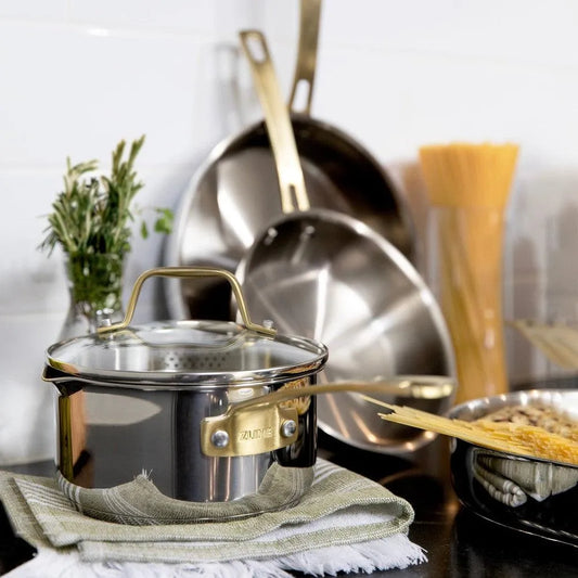 ZLINE 10-Piece Stainless Steel Non-Toxic Cookware Set (CWSETL-ST-10) 2.5QT Saucepan with glass lid on a luxury countertop.