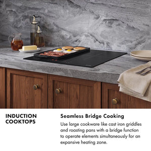 Induction Cooktops Infographic. Image: A kitchen with an induction cooktop cooking breakfast foods in a skillet. Text: Seamless Bridge Cooking. Use large cookware like cast iron griddles and roasting pans with a bridge function to operate elements simultaneously for an expansive heating zone.