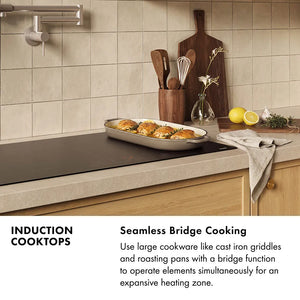 Induction Cooktops Infographic. Image: A kitchen with an induction cooktop cooking a roasting pan full of food. Text: Seamless Bridge Cooking. Use large cookware like cast iron griddles and roasting pans with a bridge function to operate elements simultaneously for an expansive heating zone.