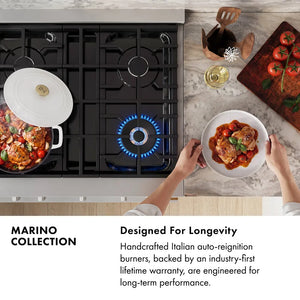 Marino Collection Infographic. Image: Top-down view of a Marino gas range with black grates and blue flame ignition, shown in a kitchen scene with a pot, plated food, a wine glass, and a cutting board. Text: Designed For Longevity. Handcrafted Italian auto-reignition burners, backed by an industry-first lifetime warranty, are engineered for long-term performance.