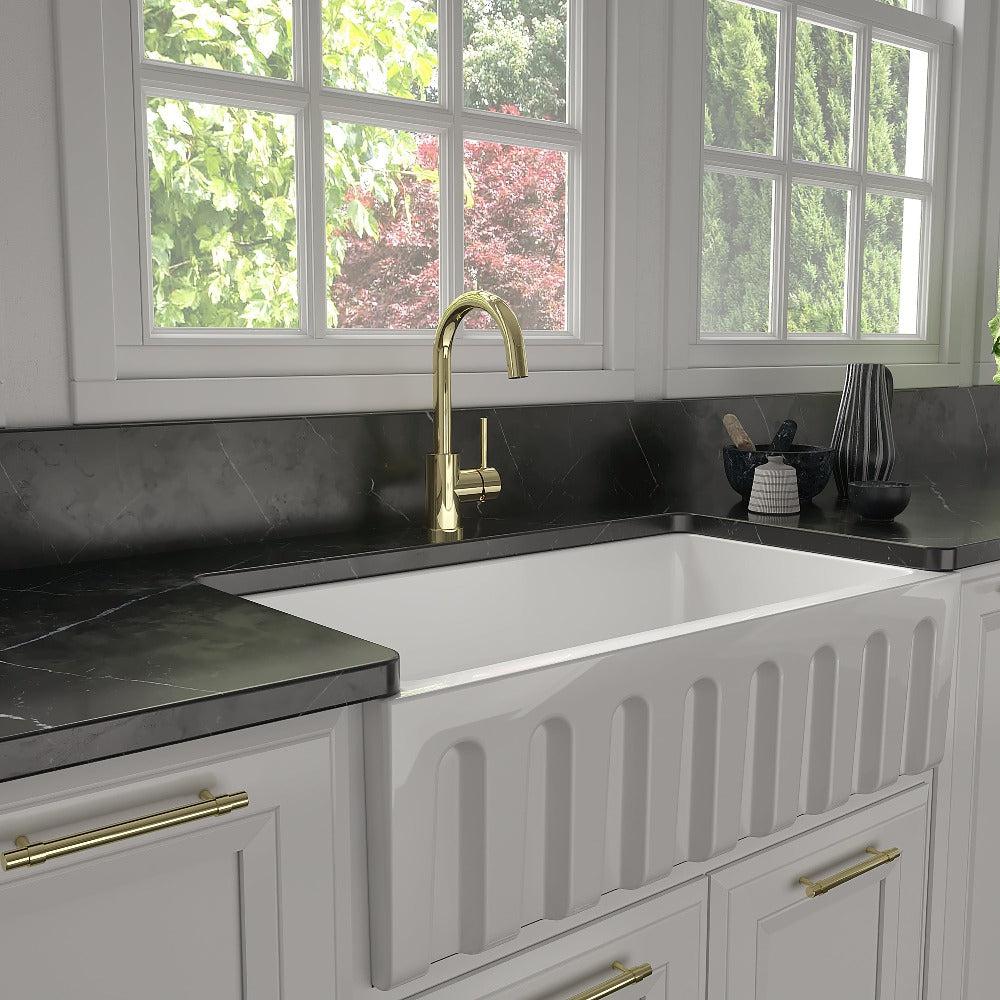 ZLINE Renoir Kitchen Faucet in Polished Gold (REN-KF-PG) in a cottage-style kitchen.