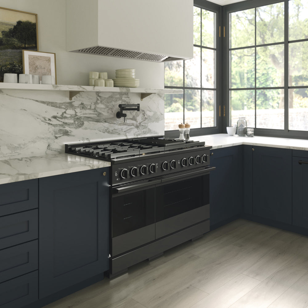ZLINE 48 in. 6.7 cu. ft. Marino Double Oven Dual Fuel Range with 8 Burner Gas Cooktop in Black Stainless Steel (MDRB-48) side, in a modern kitchen set under a white marble backsplash and a large black-framed window with a view of green trees outside.