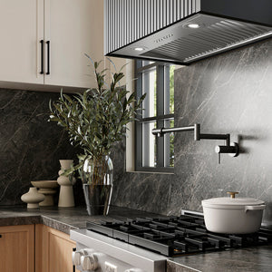 ZLINE 28 in. DuraMount™ Wall Mount Range Hood Insert in Stainless Steel (683-28) in a designer kitchen with marble backsplash, custom range hood, and decorative elements, side.