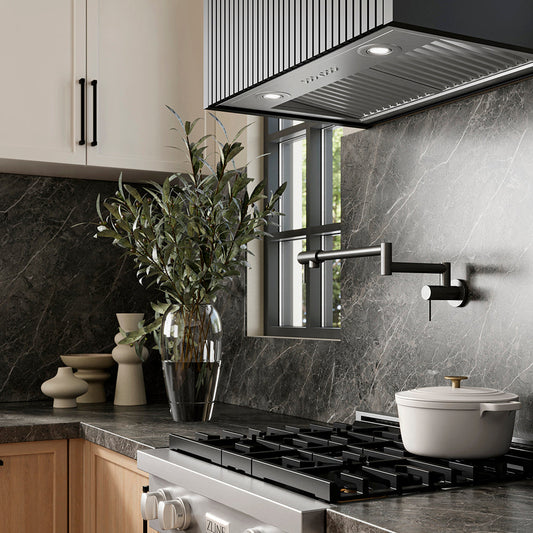 ZLINE 28 in. DuraMount™ Wall Mount Range Hood Insert in Stainless Steel (683-28) in a designer kitchen with marble backsplash, custom range hood, and decorative elements, side.
