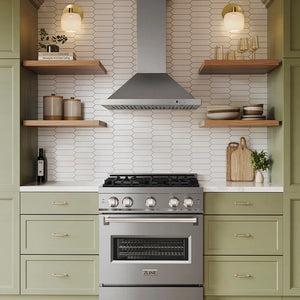A ZLINE 30 in. Convertible Vent Wall Mount Range Hood in Stainless Steel (KB-30) set in a modern kitchen with sage green cabinets, white hexagonal tile backsplash, and open wooden shelves.