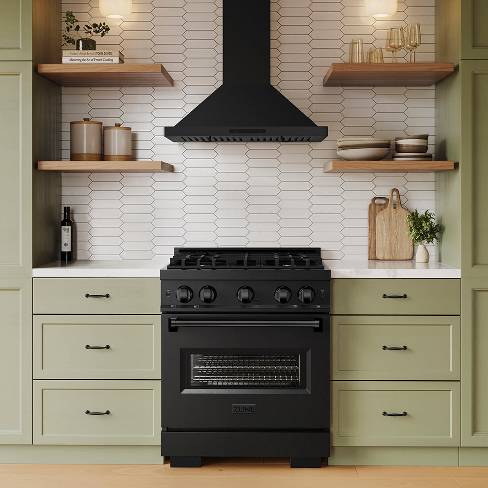ZLINE 30 in. Convertible Vent Wall Mount Range Hood in Black Stainless Steel (BSKBN-30) above a black range in a kitchen with green cabinets and wooden shelves.