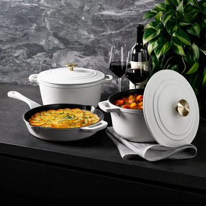 ZLINE 5-Piece Enameled Cast Iron Cookware Set in White Matte (CWSETS-WM-5) on a dark surface with a plant in the background.