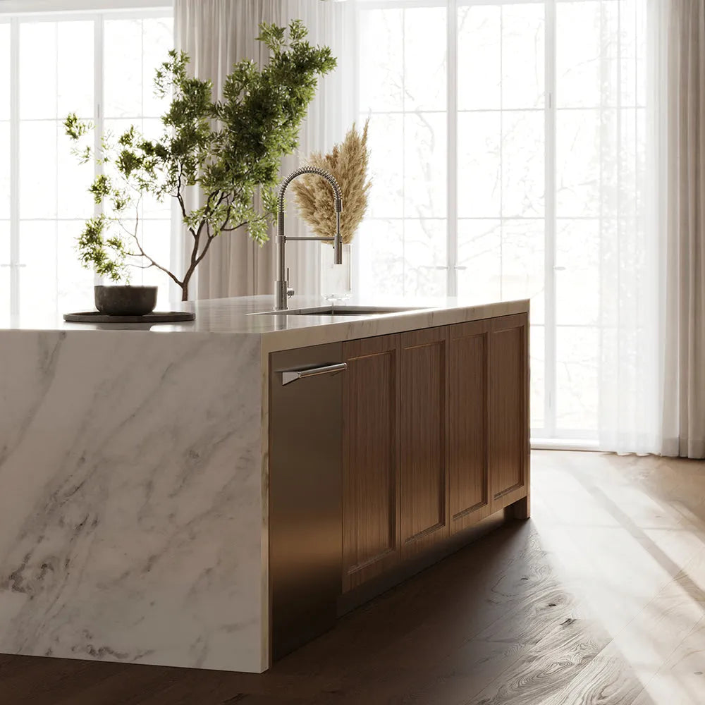 ZLINE 24 in. Monument Series 3rd Rack Dishwasher with Auto Door Open Drying, 44dBa, Stainless Steel Panel (DWMT-304-24) in a kitchen island with marble countertop and wooden cabinets, featuring a plant and decorative items.