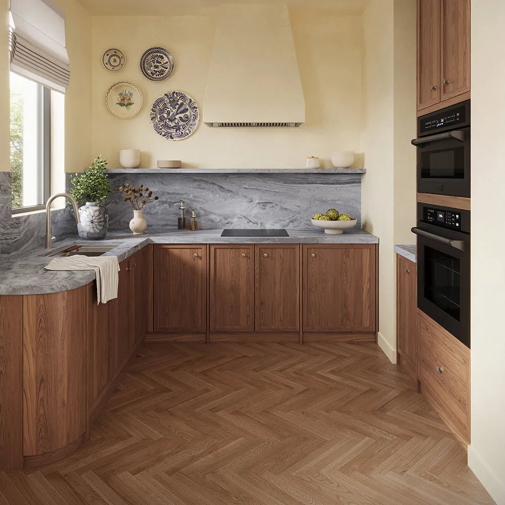ZLINE 24 in. Induction Cooktop with Anti-Scratch Glass and 3 Elements (FCIND-24) in a modern L-shaped kitchen featuring warm medium-brown wood cabinets, a gray marble countertop and backsplash, a matching wood herringbone floor, and built-in black appliances.