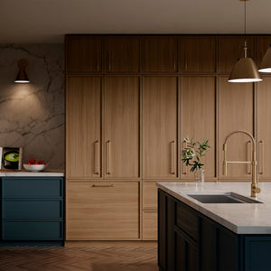 ZLINE Sierra Pull Down Spring Single Handle Kitchen Faucet in Champagne Bronze (SRA-KF-CB) in a kitchen with wooden cabinets, marble countertop, and pendant lights.