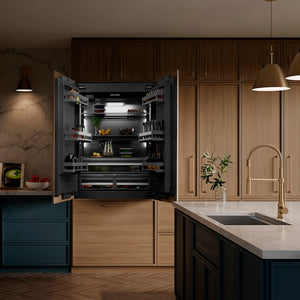 ZLINE Sierra Pull Down Spring Single Handle Kitchen Faucet in Champagne Bronze (SRA-KF-CB) in a kitchen with open refrigerator displaying various food items.