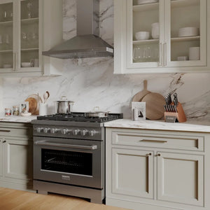 Rustic kitchen with ZLINE 36 in. 5.2 cu. ft. Paramount Gas Range with 6 Burner Cooktop and Convection Gas Oven in Stainless Steel (SGR36), marble countertop, and light gray cabinets.