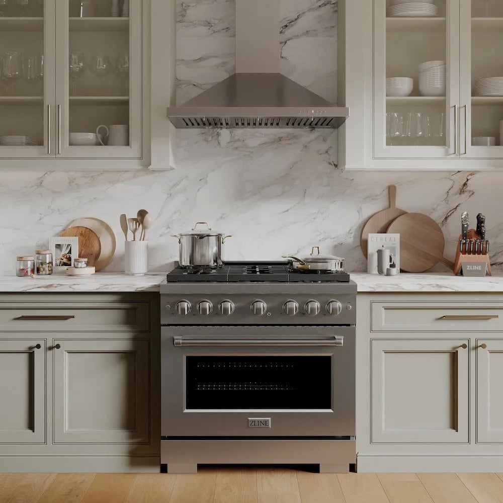 Luxury kitchen with a ZLINE 36 in. 5.2 cu. ft. Paramount Gas Range with 6 Burner Cooktop and Convection Gas Oven in Stainless Steel (SGR36) and marble backsplash