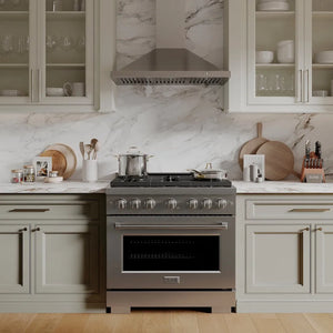 Luxury kitchen with a ZLINE 36 in. 5.2 cu. ft. Paramount Gas Range with 6 Burner Cooktop and Convection Gas Oven in Stainless Steel (SGR36) and marble backsplash