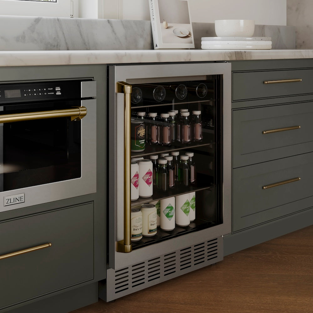 ZLINE Autograph Edition 24 in. Monument 154 Can Beverage Fridge in Stainless Steel with Champagne Bronze Accents (RBVZ-US-24-CB) in a luxury kitchen with blue cabinets.