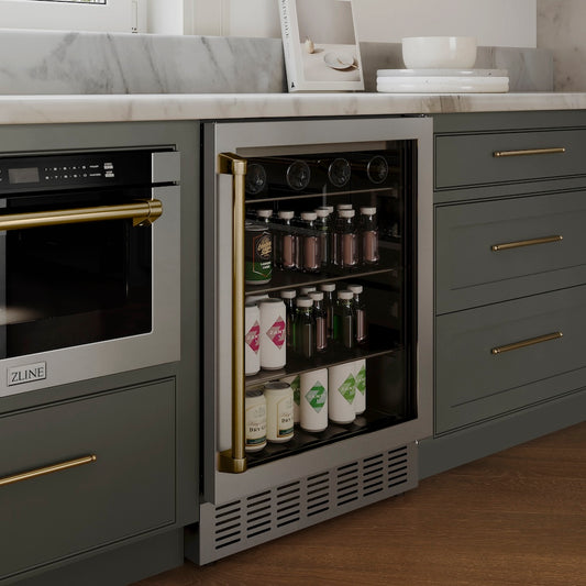 ZLINE Autograph Edition 24 in. Monument 154 Can Beverage Fridge in Stainless Steel with Champagne Bronze Accents (RBVZ-US-24-CB) in a luxury kitchen with blue cabinets.
