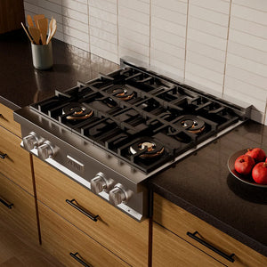 ZLINE 30 in. Classic Gas Rangetop with 4 Burner DuoPro™ Cooktop in Stainless Steel (PCRT30) in a kitchen setting with wooden cabinets and a dark countertop.