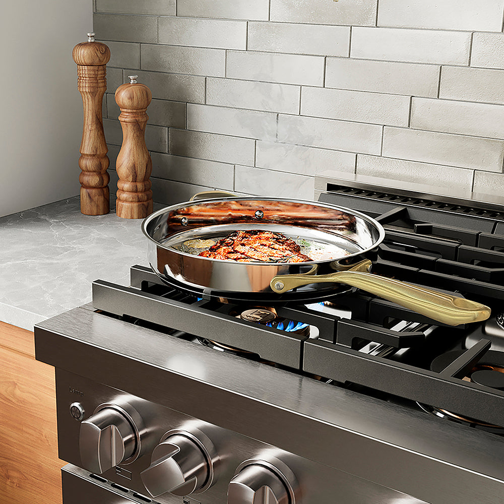 ZLINE 36 in. 5.2 cu. ft. Paramount Dual Fuel Range with 6 Burner DuoPro™ Cooktop and Electric Convection Oven in Stainless Steel (PSDR36) in a luxury kitchen with stainless steel range hood, wooden cabinets, and a light gray brick backsplash.