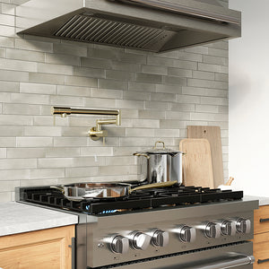 ZLINE 36 in. 5.2 cu. ft. Paramount Dual Fuel Range with 6 Burner DuoPro™ Cooktop and Electric Convection Oven in Stainless Steel (PSDR36) in a luxury kitchen with stainless steel range hood, wooden cabinets, and a light gray brick backsplash.