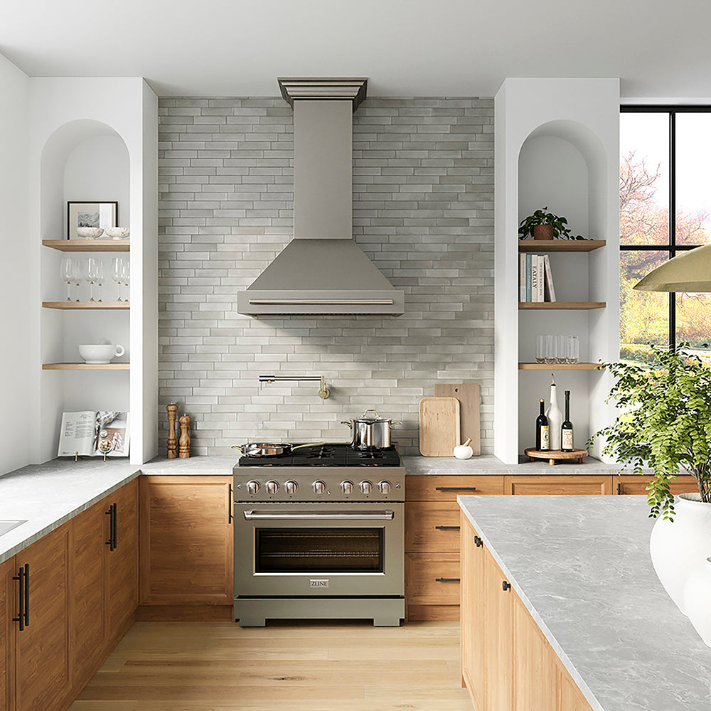 ZLINE 36 in. 5.2 cu. ft. Paramount Dual Fuel Range with 6 Burner DuoPro™ Cooktop and Electric Convection Oven in Stainless Steel (PSDR36) in a luxury kitchen with stainless steel range hood, wooden cabinets, and a light gray brick backsplash.