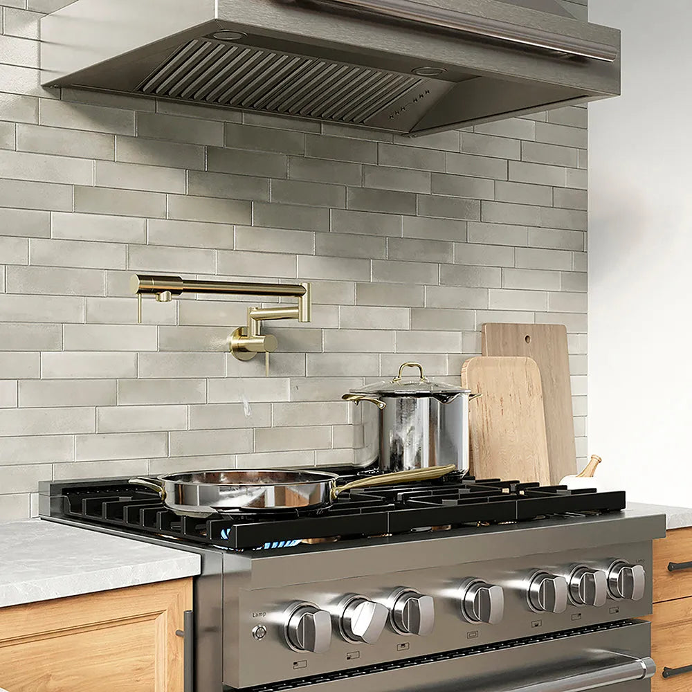 ZLINE 36 in. 5.2 cu. ft. Paramount Gas Range with 6 Burner DuoPro™ Cooktop and Convection Gas Oven in Stainless Steel (PSGR36) with pots and pans on a kitchen counter with tiled backsplash