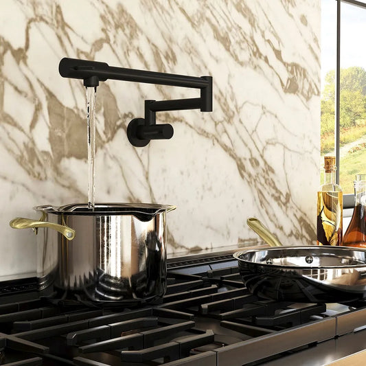 ZLINE Gemini Pot Filler in Matte Black (GEM-FPF-MB) above a stainless steel pot on a gas range against a marble wall.