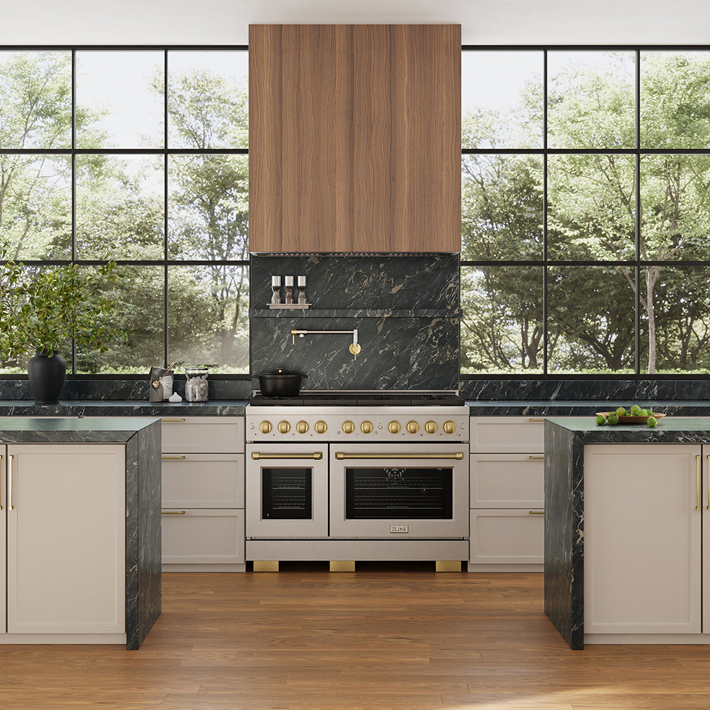 ZLINE 46 in. DuraMount™ Wall Mount Range Hood Insert in Stainless Steel (683-46) in a designer kitchen with a custom wood range hood above a stainless steel range next to large windows.