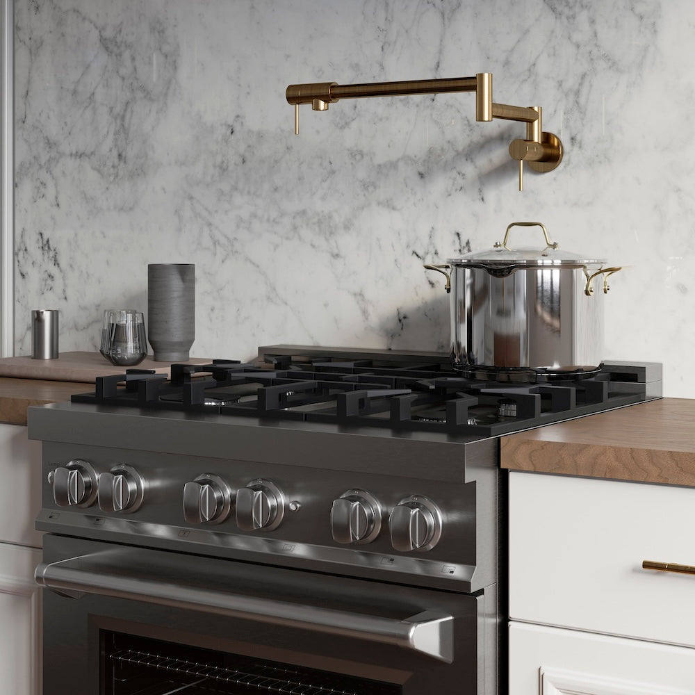 ZLINE Gemini Pot Filler in Polished Gold (GEM-FPF-PG) in a kitchen with a gas range, pots, and a marble backsplash.