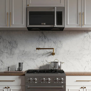 ZLINE 30 in. Stainless Steel Over the Range Convection Microwave Oven with Traditional Handle (MWO-OTR-H-30) in a white marble kitchen with wood details.