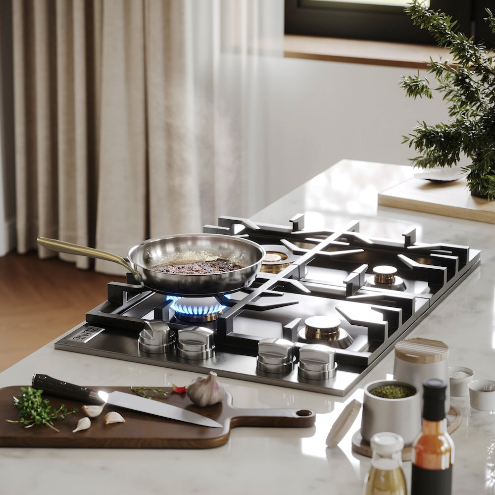 ZLINE 30 in. Gas Cooktop with 4 Brass Burners and Black Porcelain Top (RC-BR-30-PBT) with a frying pan on a kitchen counter