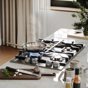 ZLINE 30 in. Gas Cooktop with 4 Brass Burners and Black Porcelain Top (RC-BR-30-PBT) with a frying pan on a kitchen counter