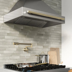 ZLINE Autograph Edition 36 in. Wall-Mount Range Hood Helix Handle (Set of 1) in Champagne Bronze (RHHZ-K-CB-36) installed in a designer kitchen.