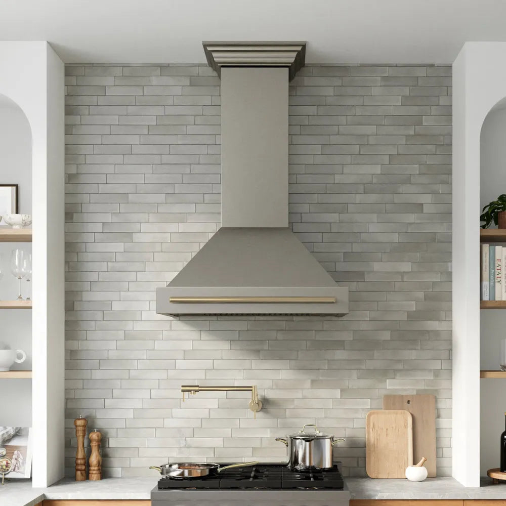 ZLINE Autograph Edition 36 in. Wall-Mount Range Hood Helix Handle (Set of 1) in Champagne Bronze (RHHZ-K-CB-36) installed in a designer kitchen.