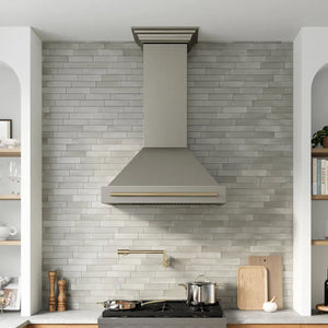 ZLINE Autograph Edition 36 in. Wall-Mount Range Hood Helix Handle (Set of 1) in Champagne Bronze (RHHZ-K-CB-36) installed in a designer kitchen.