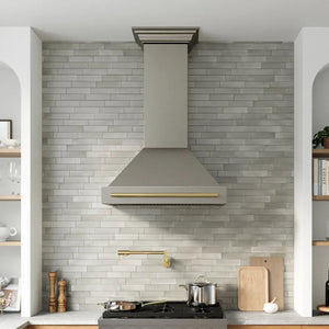 ZLINE Autograph Edition 36 in. Wall-Mount Range Hood Helix Handle (Set of 1) in Polished Gold (RHHZ-K-G-36) installed in a designer kitchen.