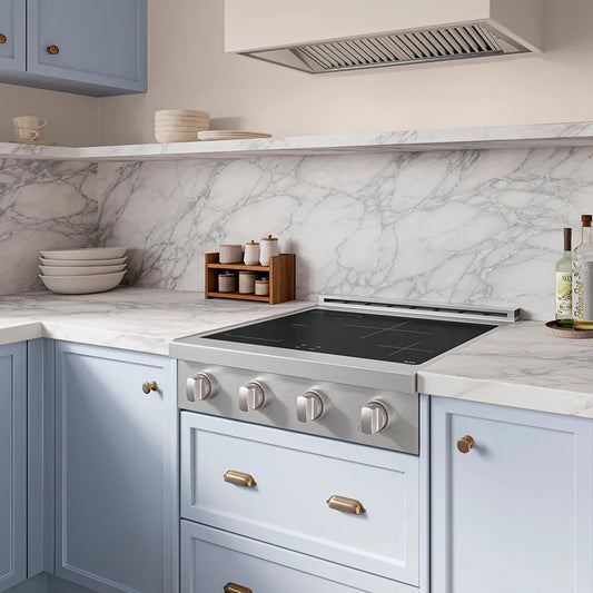 ZLINE 30 in. Paramount Induction Rangetop with 4 Element Cooktop in Stainless Steel (SINRT30) in a designer kitchen with marble backsplash, light blue cabinets, angled.
