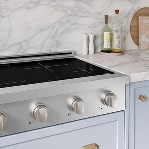 ZLINE 30 in. Paramount Induction Rangetop with 4 Element Cooktop in Stainless Steel (SINRT30) in a designer kitchen with marble backsplash, light blue cabinets, angled.