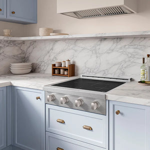ZLINE 30 in. Paramount Induction Rangetop with 4 Element Cooktop in Satin Stainless Steel (SINRTS-30) in a designer kitchen with marble backsplash, light blue cabinets, angled.